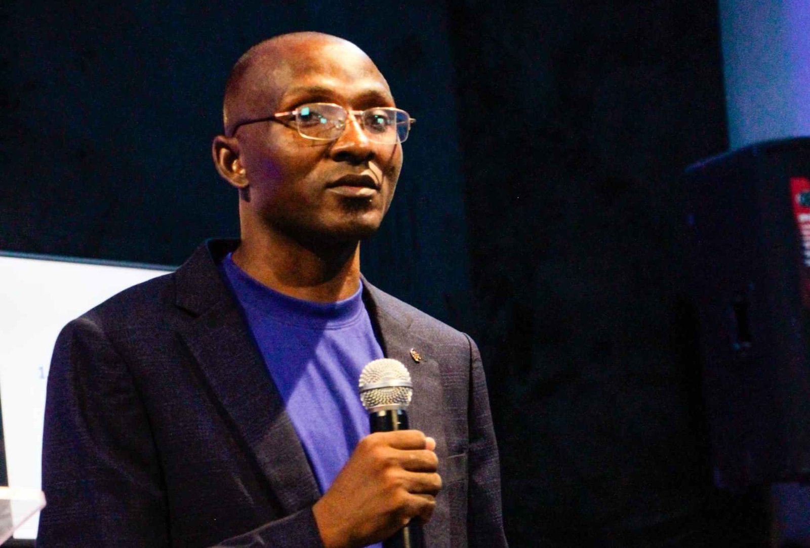 Anzolo at friends connect leading the africa awakening standing pefect with open palm